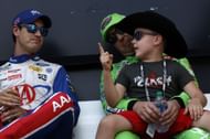 NASCAR Cup Series Auto Trader EchoPark Automotive 500 FORT WORTH, TEXAS - SEPTEMBER 25: Joey Logano, driver of the #22 AAA Insurance Ford, (L) speaks with Brexton Busch, son of Kyle Busch, driver of the #18 Interstate Batteries Toyota, backstage during pre-race ceremonies prior to the NASCAR Cup Series Auto Trader EchoPark Automotive 500 at Texas Motor Speedway on September 25, 2022 in Fort Worth, Texas. (Photo by Chris Graythen/Getty Images)